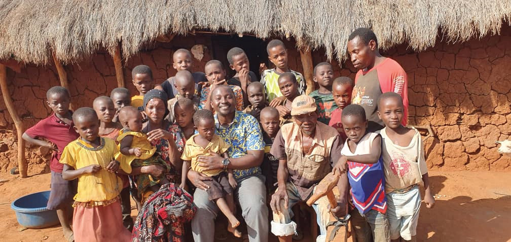 Fatima from Mkinga Village smiling while holding a water container